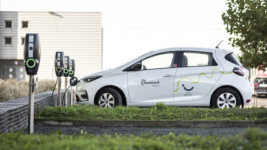 Climate and environment - electric first Fluvius car at a charging station