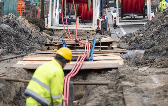 Arbeiders trekken kabels van een haspel